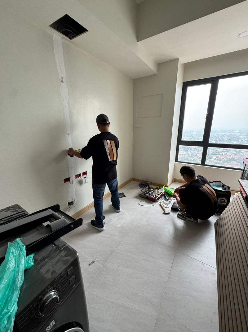 Wood Panel Philippines Contractor working on a renovation project in an apartment with tools and materials scattered around.