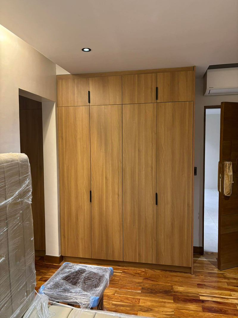 Wooden wardrobe in a room with construction materials on the floor By Wood Panel Philippines.