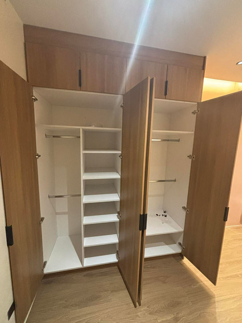 Open wooden wardrobe with shelves in a room By Wood Panel Philippines.