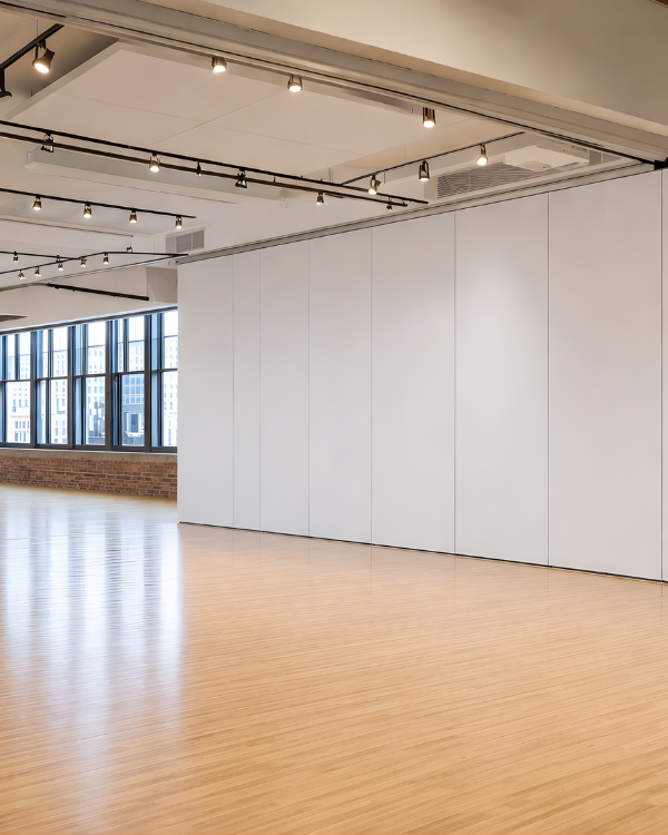 Modern room with white walls, wooden floor, and ceiling lights Soundproof Wall Partition