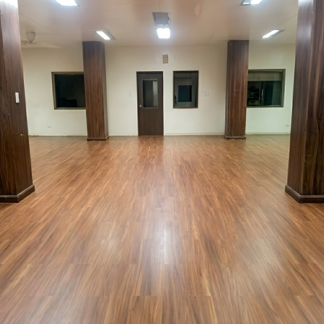 Large room with vinyl flooring and columns, empty and well-lit by Wood Panel Philippines