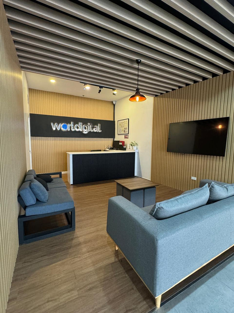Modern office waiting area with blue couches, a reception desk, and 'worldigital' sign By Wood Panel Philippines