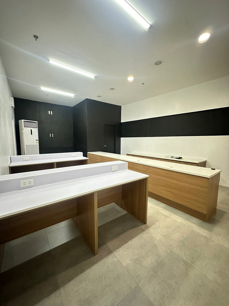 Modern office space with wooden desks and white walls By Wood Panel Philippines