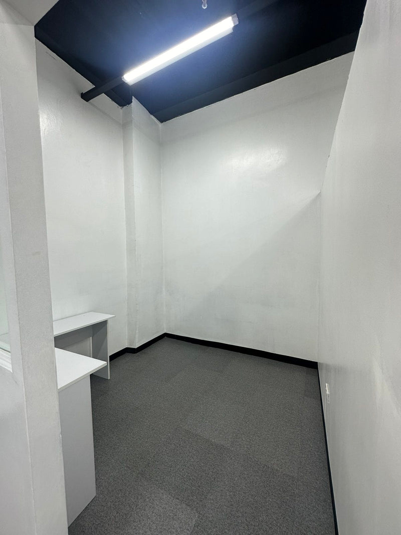 Small office cubicle with white walls and a gray floor By Wood Panel Philippines
