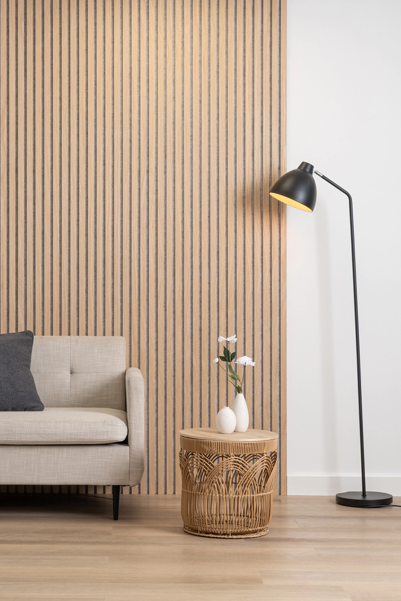 Modern living room with a striped Oak Beige Acoustic Wood Wall Panel, sofa, side table, and floor lamp.